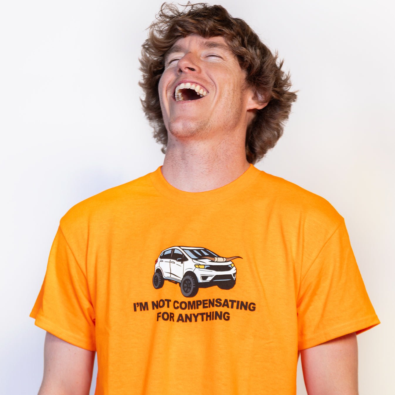 I'm Not Compensating Orange Tee - Danny Duncan